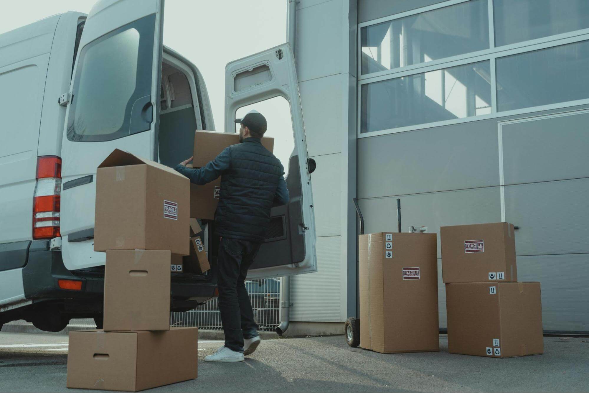 Man loading boxes on vehicle