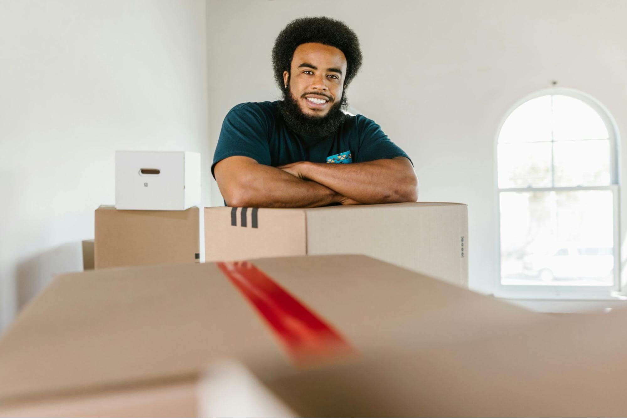 Man resting his arms on top of the box